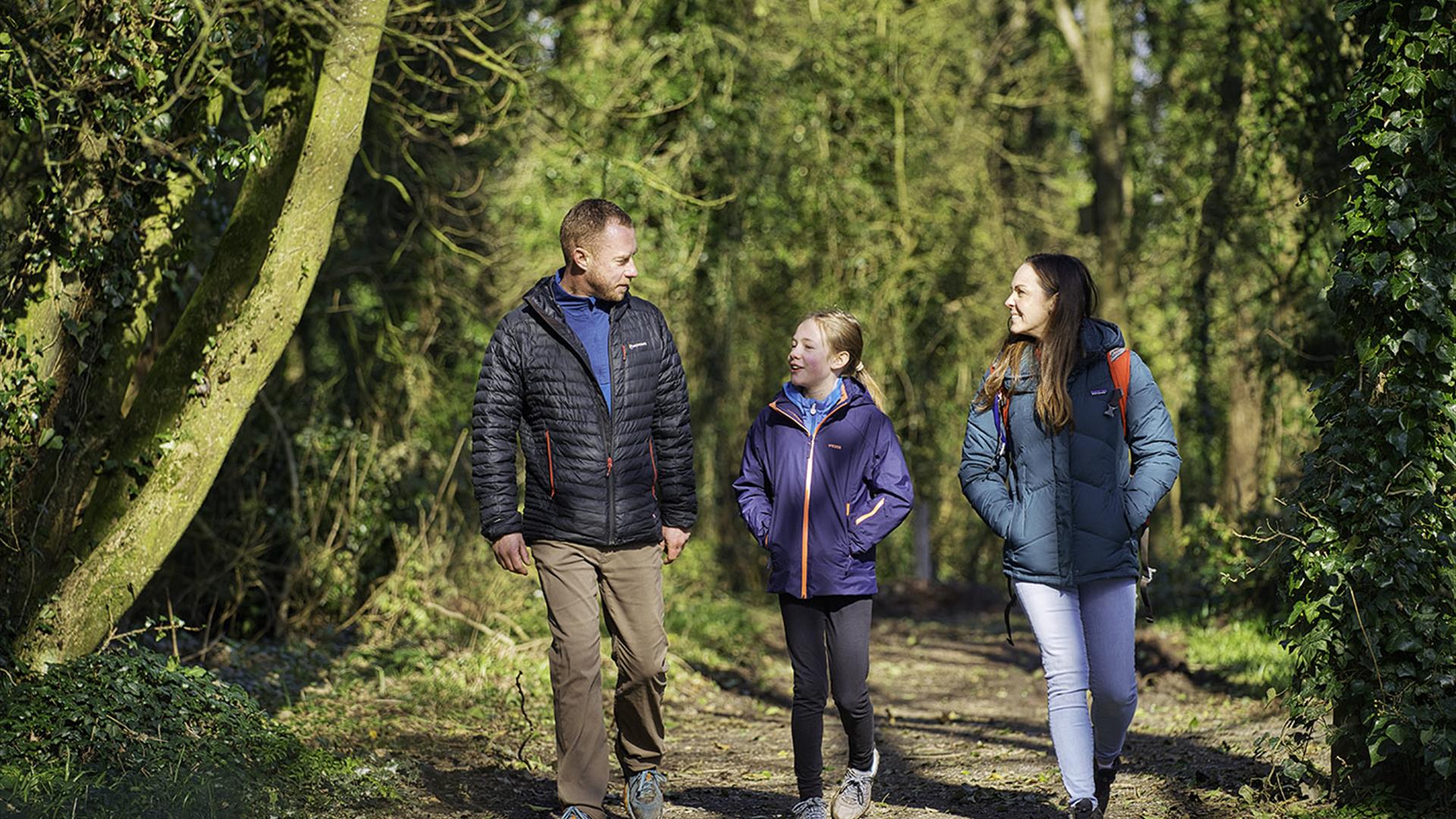 A family walk along a woodland path at Ballyronan Wood.
