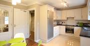 open plan kitchen and dining area with amenities