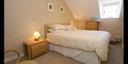 double room with bedside lockers and chest of drawers