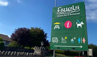 A picture of a sign post for Friels Bar and Restaurant