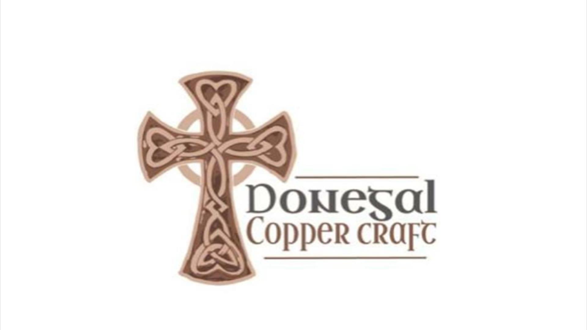Image of a brown Celtic cross and Gonegal copper craft written