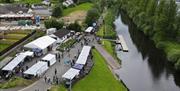 Arial image of the market and stalls beside the river at Toome