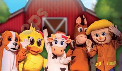 A picture of Animals in front of a Barn