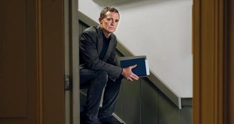 A picture of Patrick Radden Keefe on a staircase