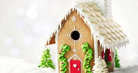 A gingerbread house decorated with white icing