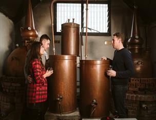 A couple enjoying a tour of whiskey making process at Killowen Distillery.