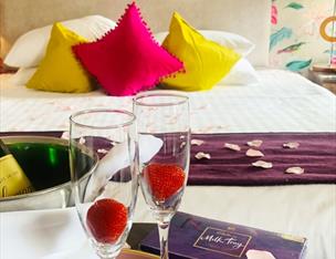 Places to stay in Warrenpoint - picture shows a large bed with complimentary treats.