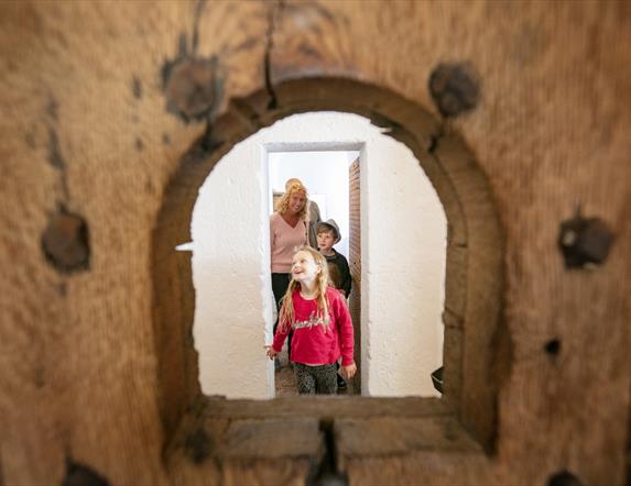 A family exploring the restored cell block