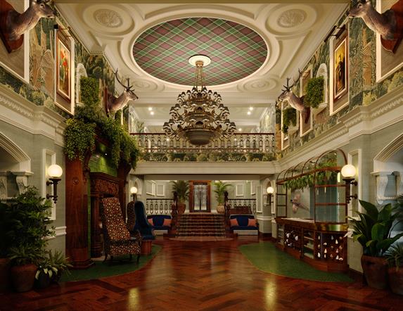 Grand lobby of Slieve Donard with dark wooden floors, lots of greenery and a large chandelier.