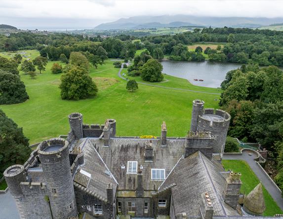 Aerial shot of Castlewellan Historic Demesne taken above the castle, with the Mourne Mountains in the distance.