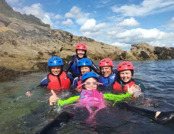 Family enjoying the water (wet bouldering) on a bank holiday