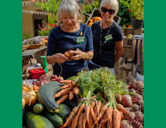 Two Trust Volunteers with locally grown produce
