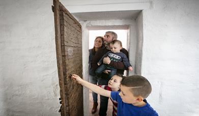 family enjoying a tour of Down County Museum's cells