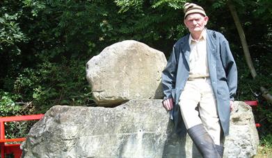Man leaning on stone