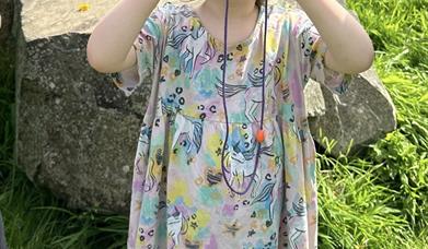 Child looking through binoculars