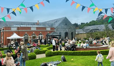 Event in the Walled Garden, Montalto with lots of people and bunting