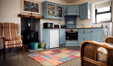 Kitchen area with stove and fireside seating