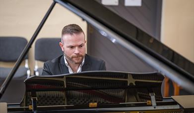 David Quigley plays a grand piano