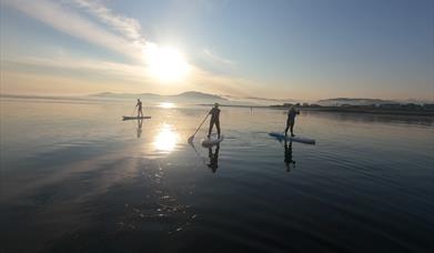 floating into the sunset at Greencastle beach, mourne mountains