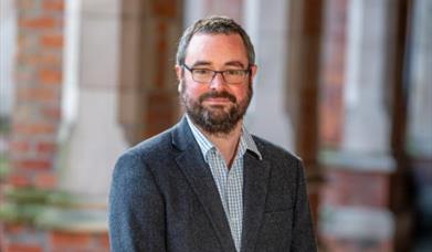 Portrait photo of the speaker, Dr Andrew Holmes.