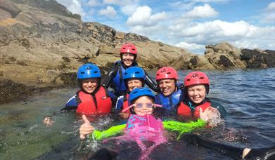 Family enjoying the water (wet bouldering) on a bank holiday