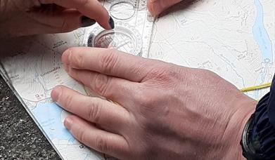 Compass being used to locate ourselves on the mountain