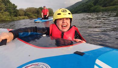 Woman smiling on a great paddle board session - Carlingford Lough