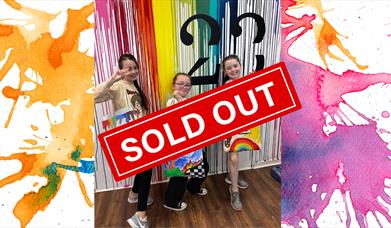 Children holding up tote bags they designed at Studio 23 for Newry Arts Festival.