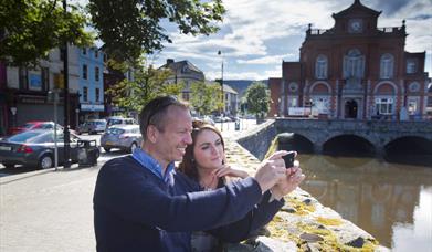 Couple taking a selfie (at Newry Town Hall) enjoying themselves on The Story of Newry Walking Tour.