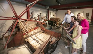 Family looking at objects on display in Down County Museum exhibition