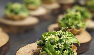 Supper Club at Scopers, Dundrum. Tasting menu of small parcels with green foilage with truffle shavings.