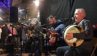 Guitar, Accordion and Bodhrn Drum played by band 'Parcel of Rouges'