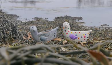 Two painted ceramic seals on the bay