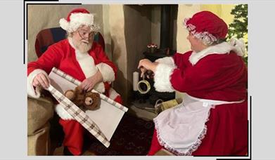 Santa and Mrs Claus wrap presents together