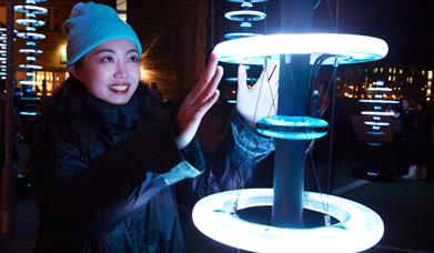 Visitors enjoying 'Illumaphonium: halo' interactive light and sound installation in Newry City this February.