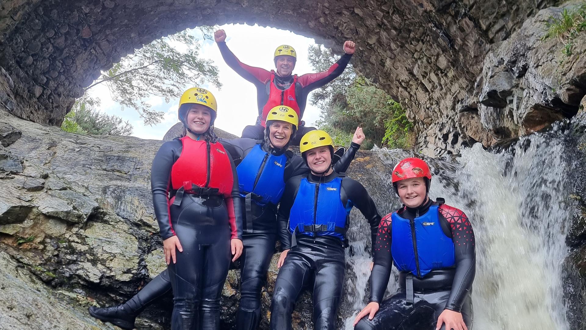 Group of people stopping for a pic under the bloody bridge waterfall