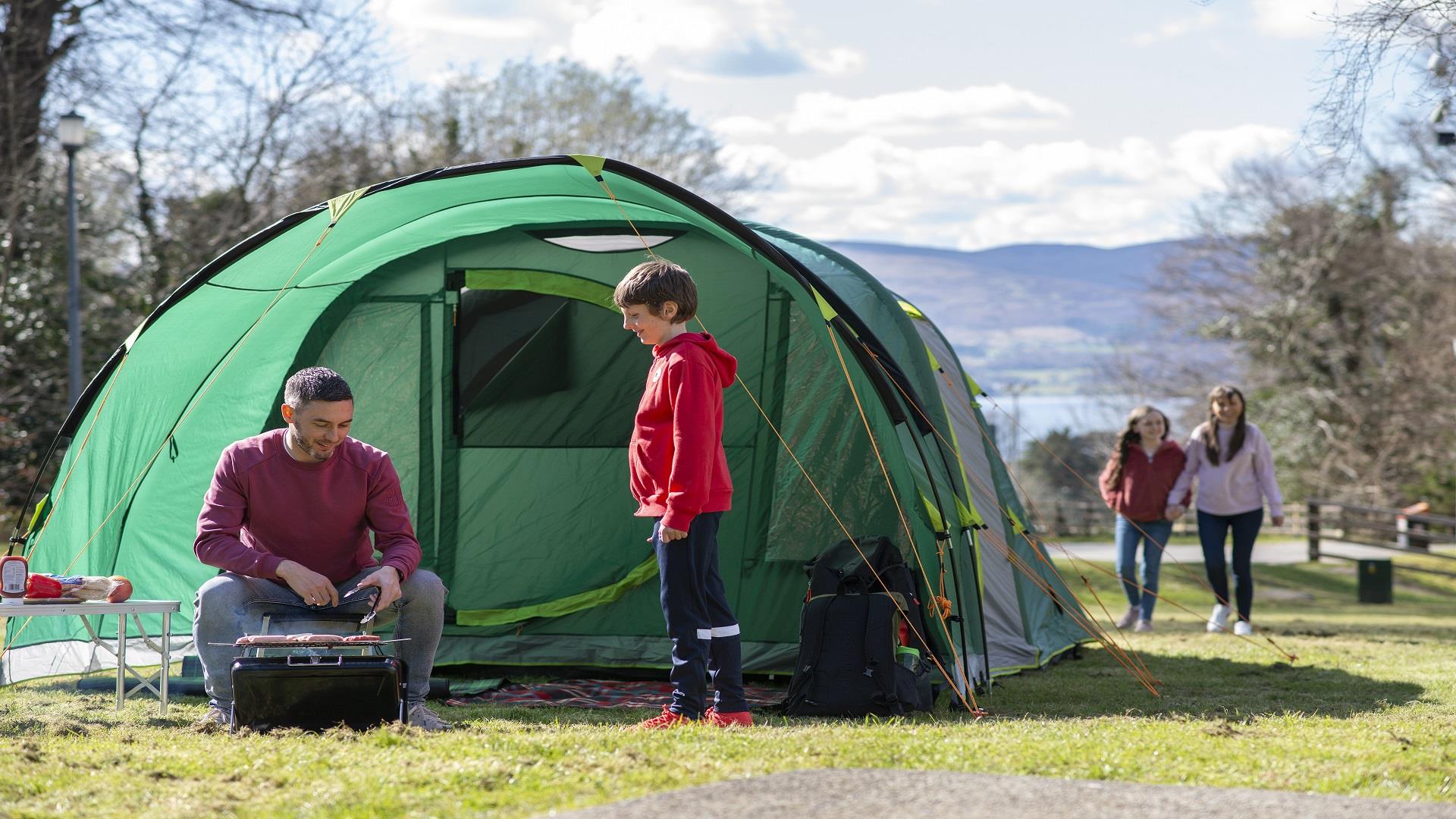 Family enjoying a BBQ infront of their tent in Kilbroney Park