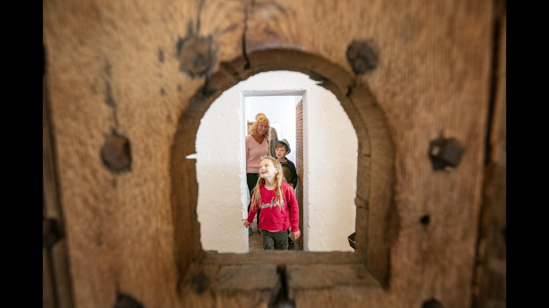 A family exploring the restored cell block