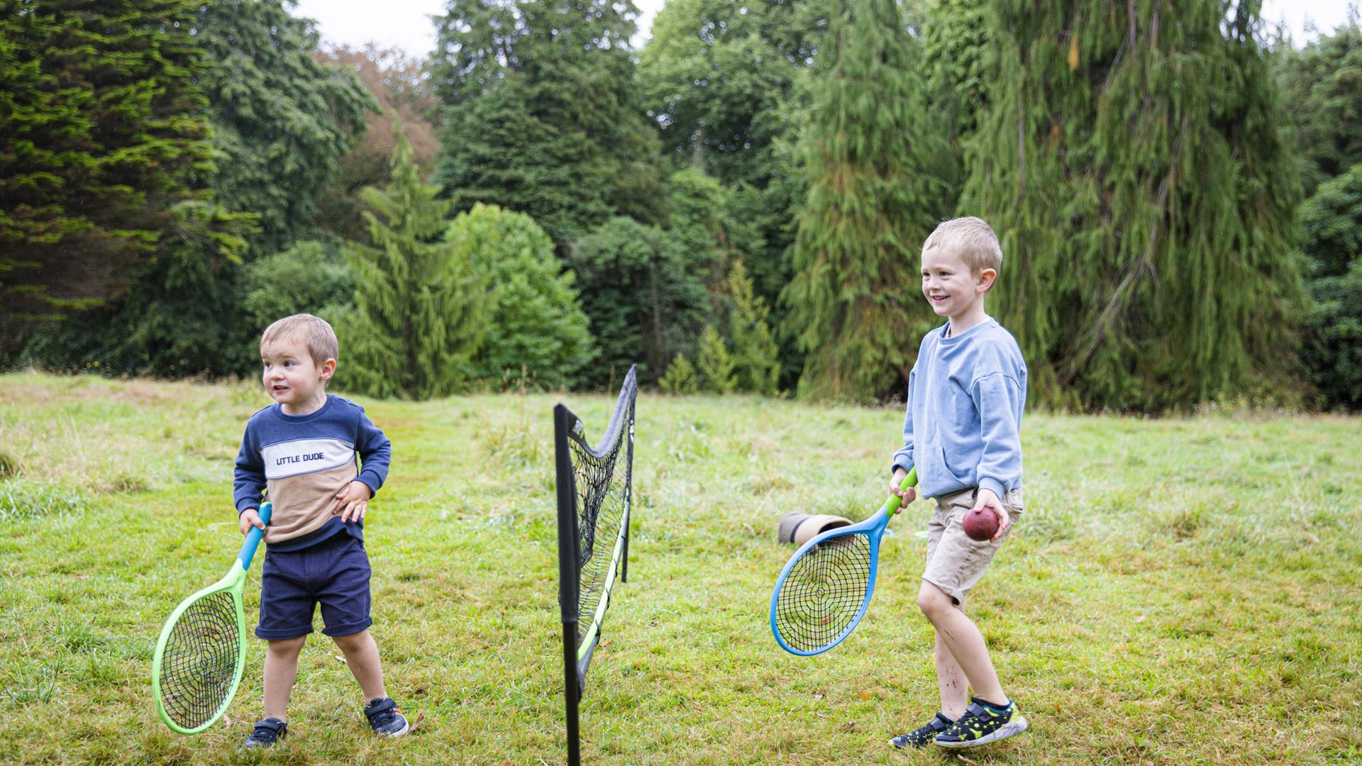 Two boys playing tennis at Rowallane Garden