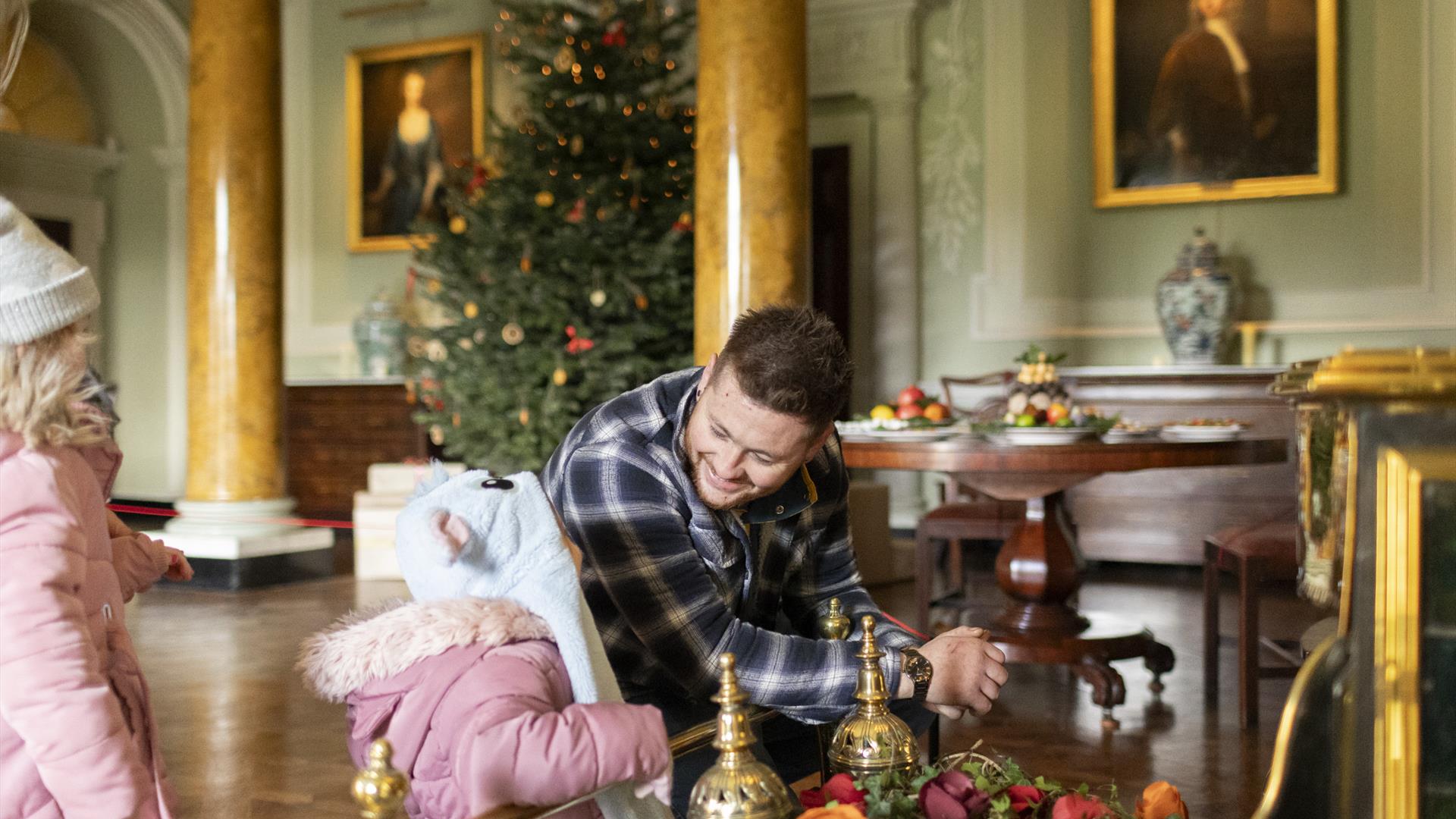 Dad & daughter talking at Christmas-dressed Castle Ward.