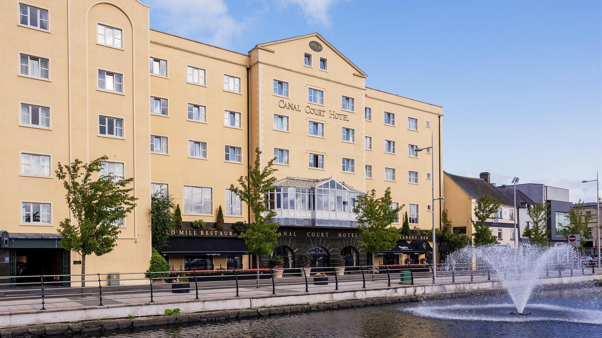 View of the front of the Canal Court Hotel and Spa building, fountain also in the picture.