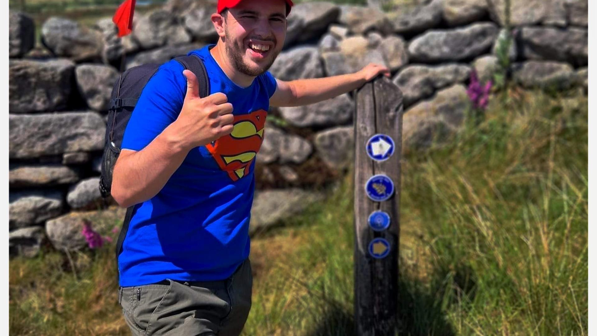Nathan posing at the way mark sign
