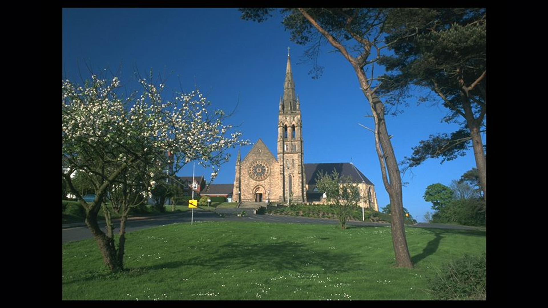 St Patrick's Church, Downpatrick with grass area and trees