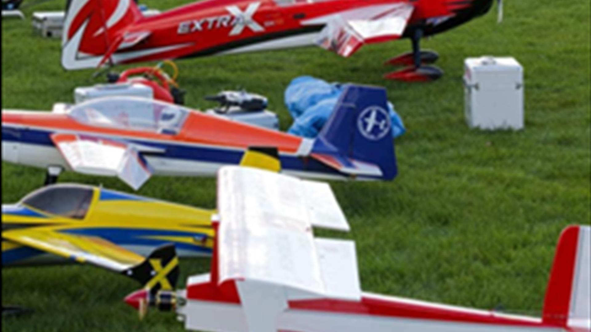 Model aeroplanes sitting on the grass ready to fly.