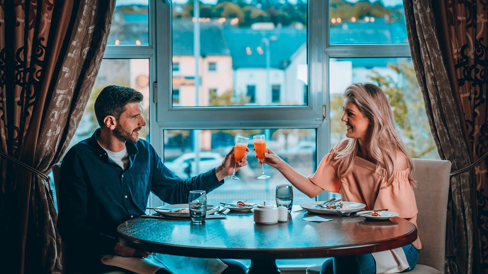 Couple enjoying food and drink at Canal Court Hotel over looking Newry Canal