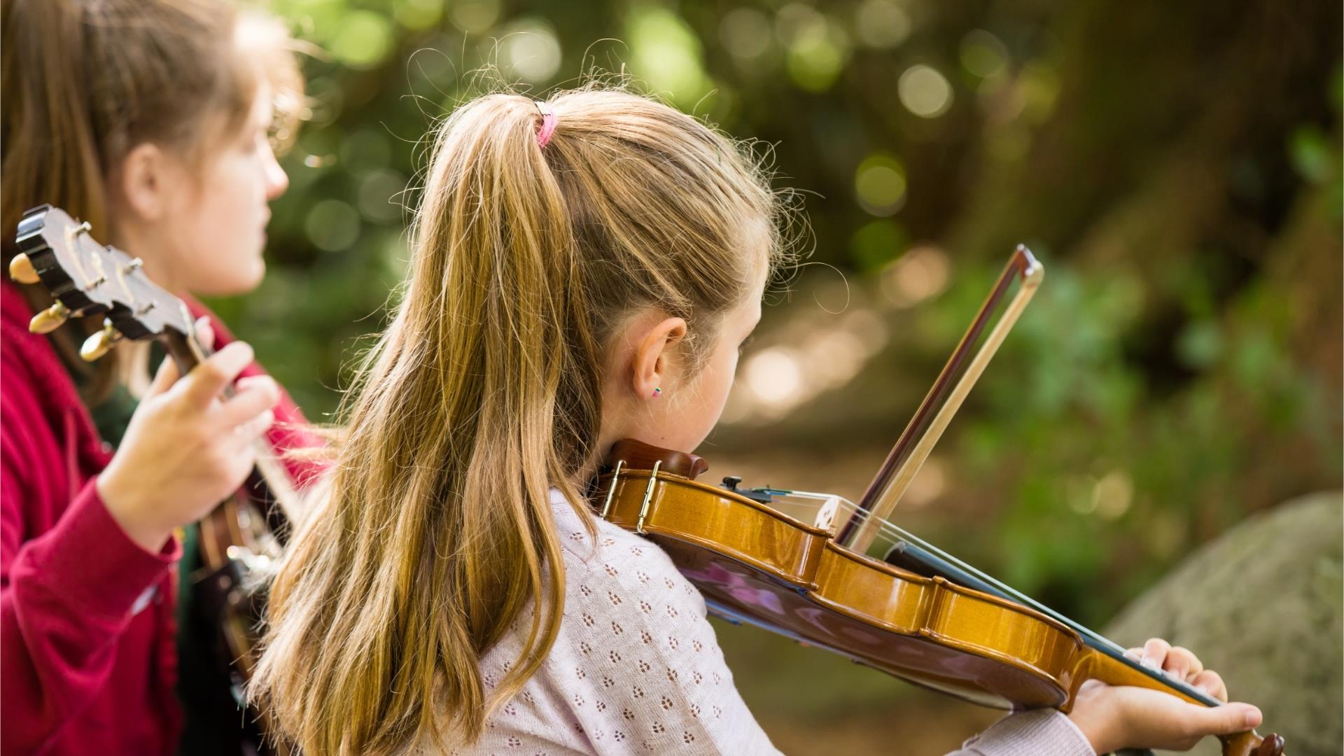 Homegrown Harmonies, two girls playing instruments. A Celebration of Traditional Music & Culture
