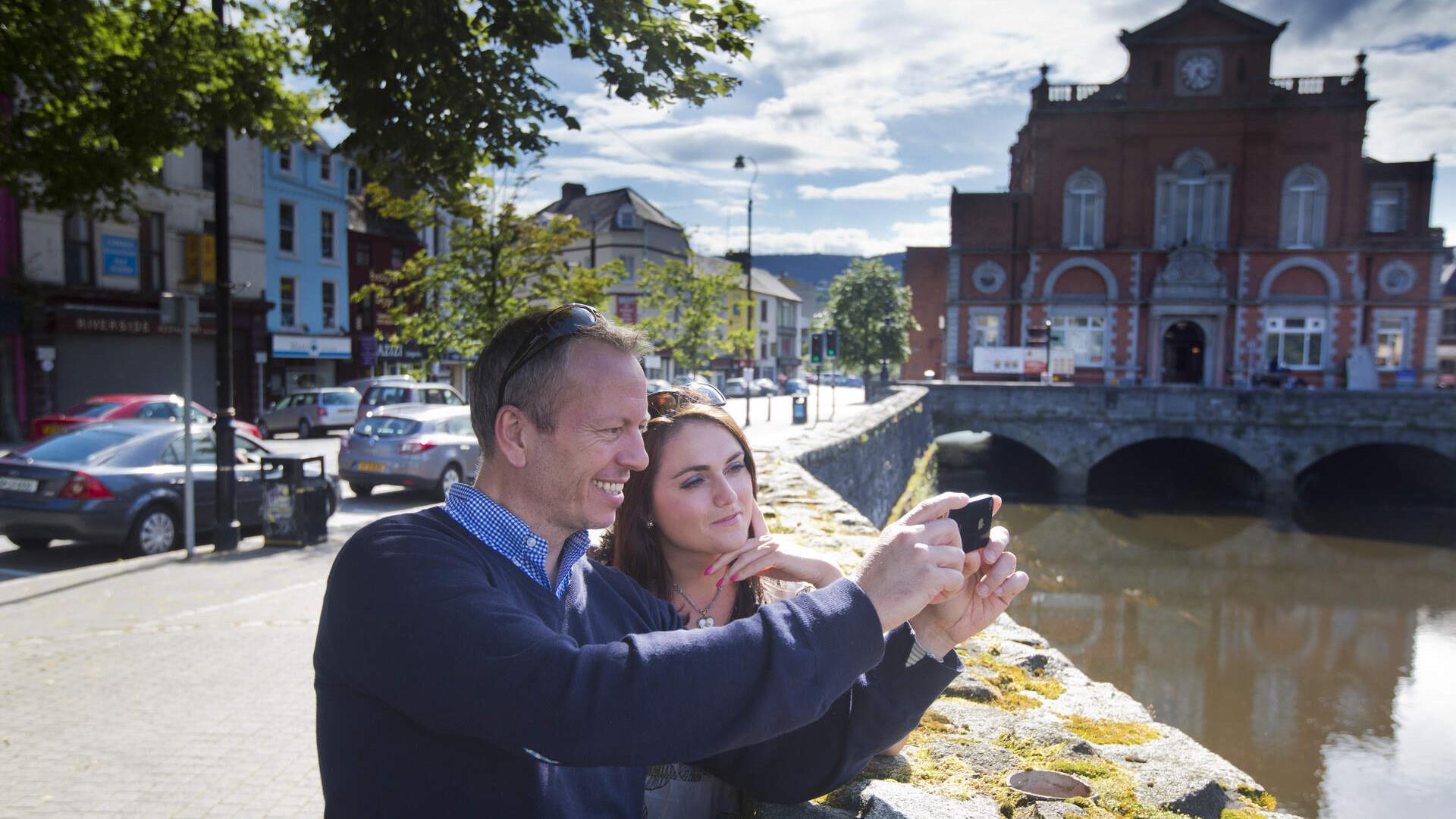 Couple taking a selfie (at Newry Town Hall) enjoying themselves on The Story of Newry Walking Tour.