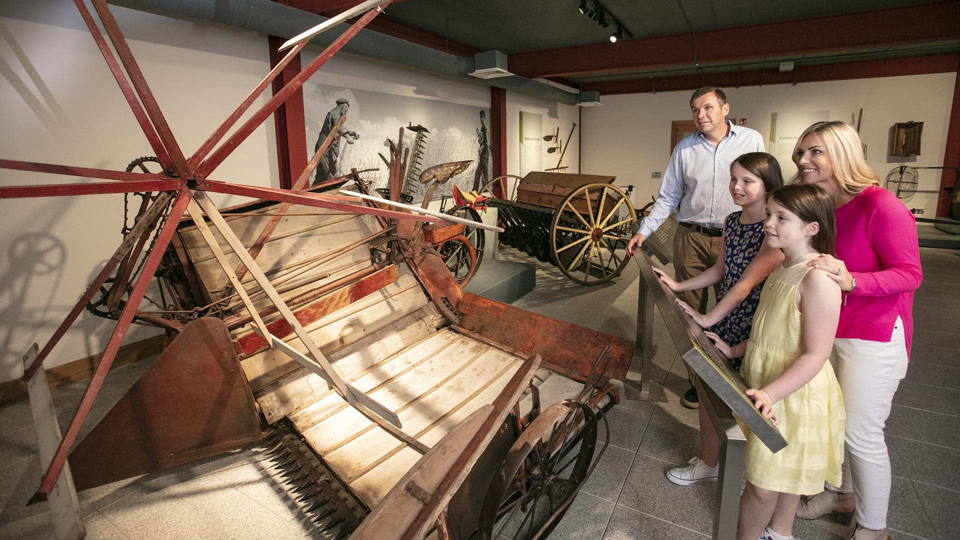 Family looking at objects on display in Down County Museum exhibition