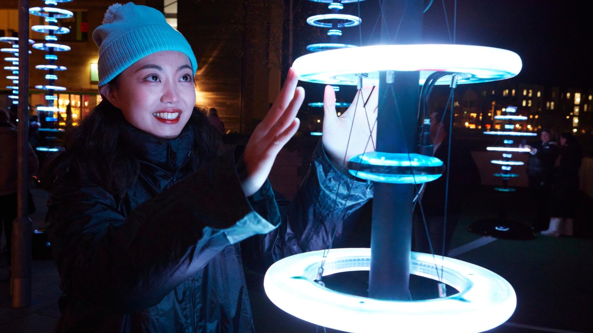 Visitors enjoying 'Illumaphonium: halo' interactive light and sound installation in Newry City this February.