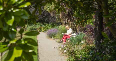 Woman taking a moment to reflect in Castle Ward's Sunken Garden